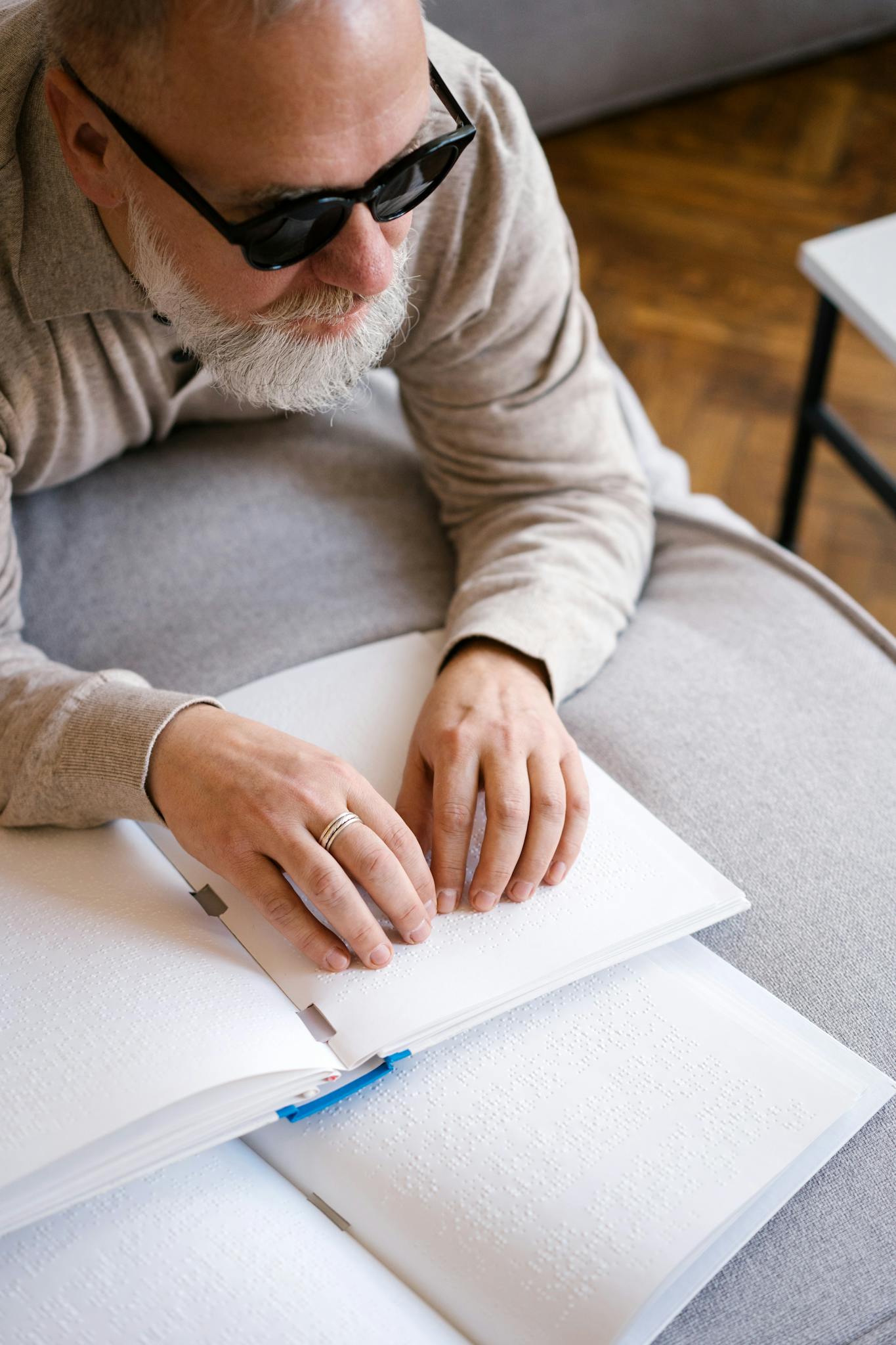 Man in Gray Sweater Writing on White Paper