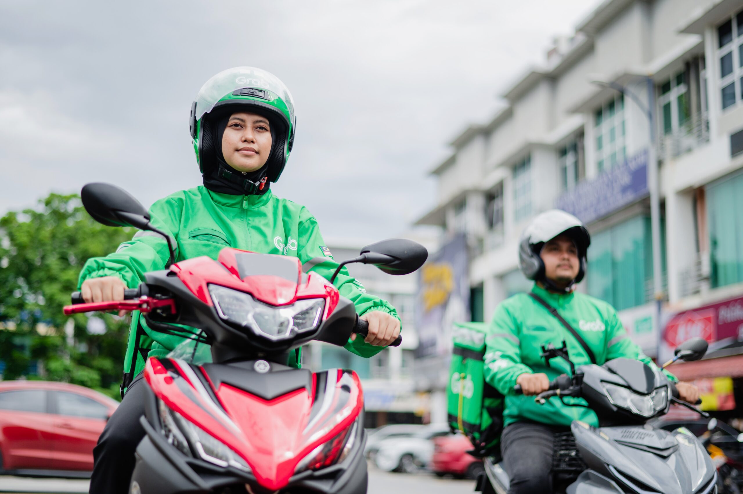 a couple of people riding on the back of motorcycles